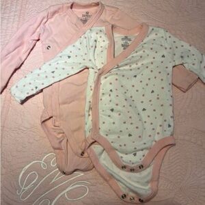 The Honest Company Pink and White onesies